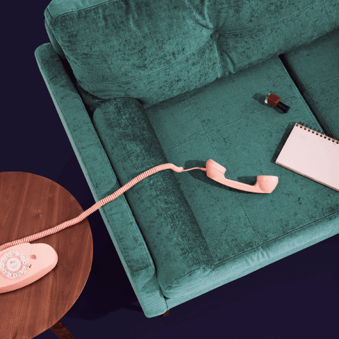 Phone and note pad on a couch